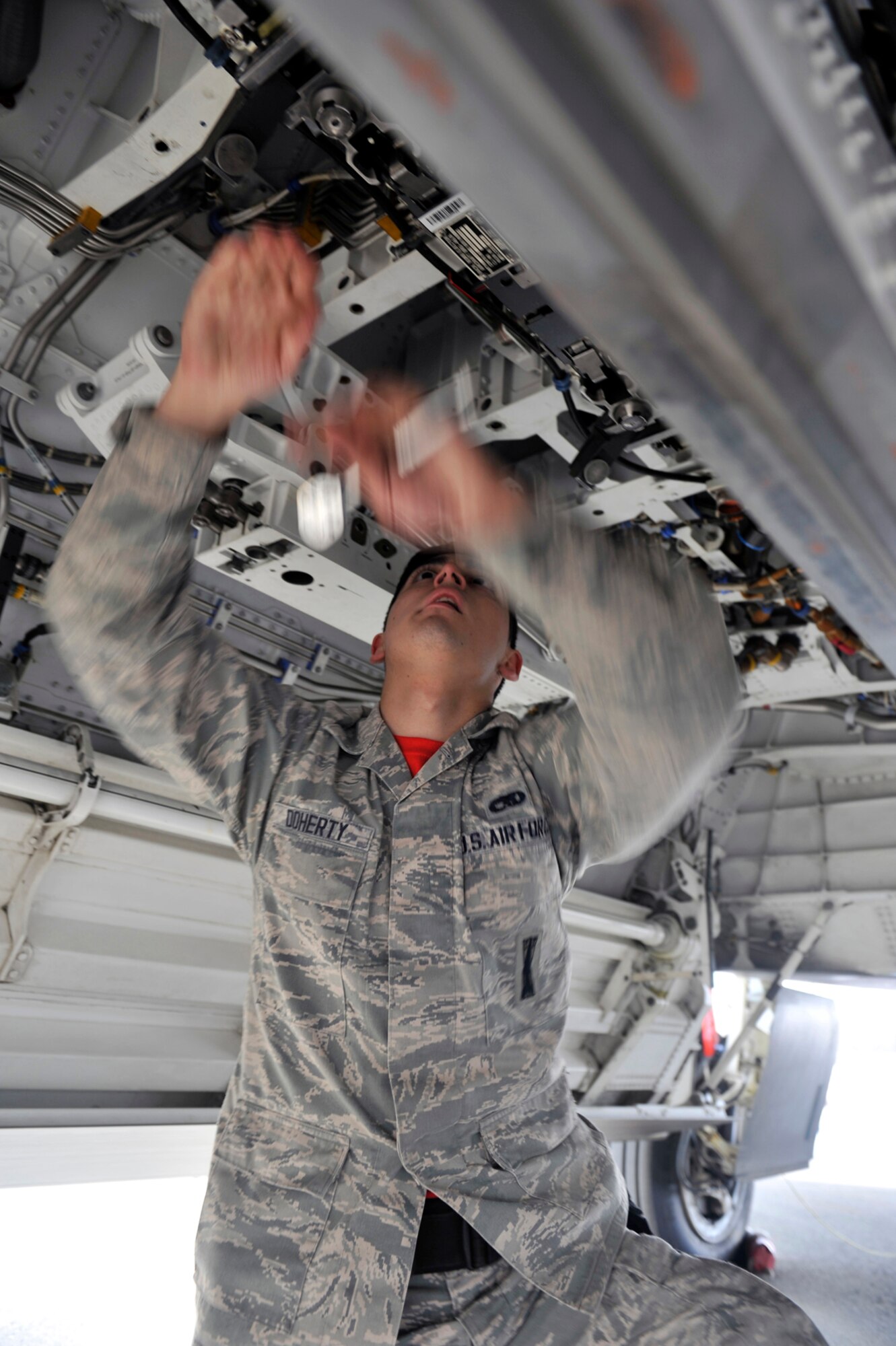 Senior Airman Stephan Doherty, 90th Fighter Squadron weapons load crew member, checks weapon compartments in the main loading bay of an F-22 Raptor during a 3rd Maintenance Group load crew competition on Joint Base Elmendorf-Richardson, Alaska, April 18, 2014. An MJ-1 Lift Truck was used to transport a Guided Bomb Unit-32 bomb into the weapon compartment during the load portion of the competition. (U.S. Air Force photo/Airman 1st Class Tammie Ramsouer)