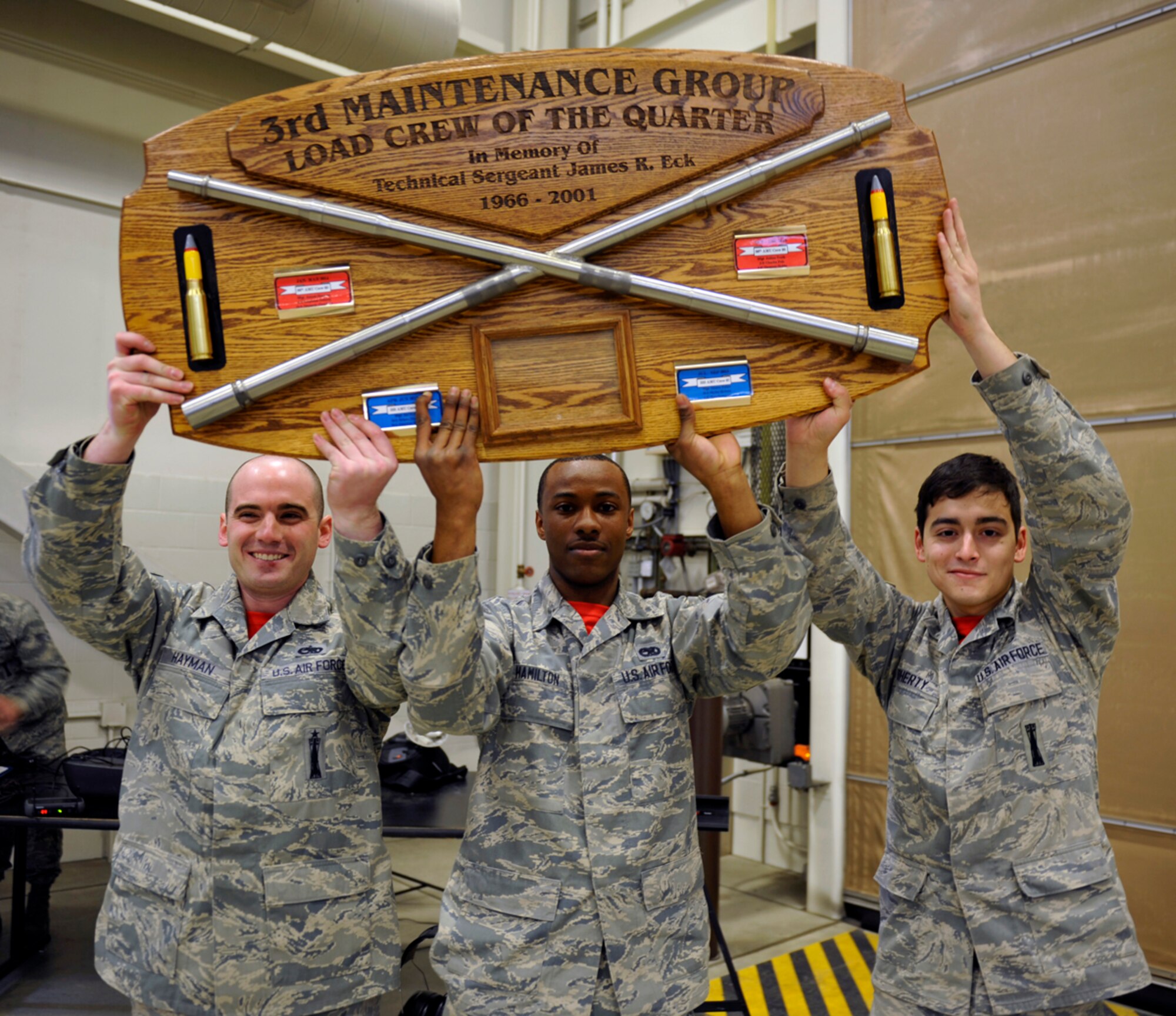The 90th Aircraft Maintenance Unit load crew lifts the 3rd Maintenance Group Load Crew of the Quarter award after a load competition on Joint Base Elmendorf-Richardson, Alaska, April 18, 2014. The 90th and 525th aircraft maintenance units train regularly to be proficient at their jobs, including competing in quarterly loading competitions. (U.S. Air Force photo/Airman 1st Class Tammie Ramsouer)