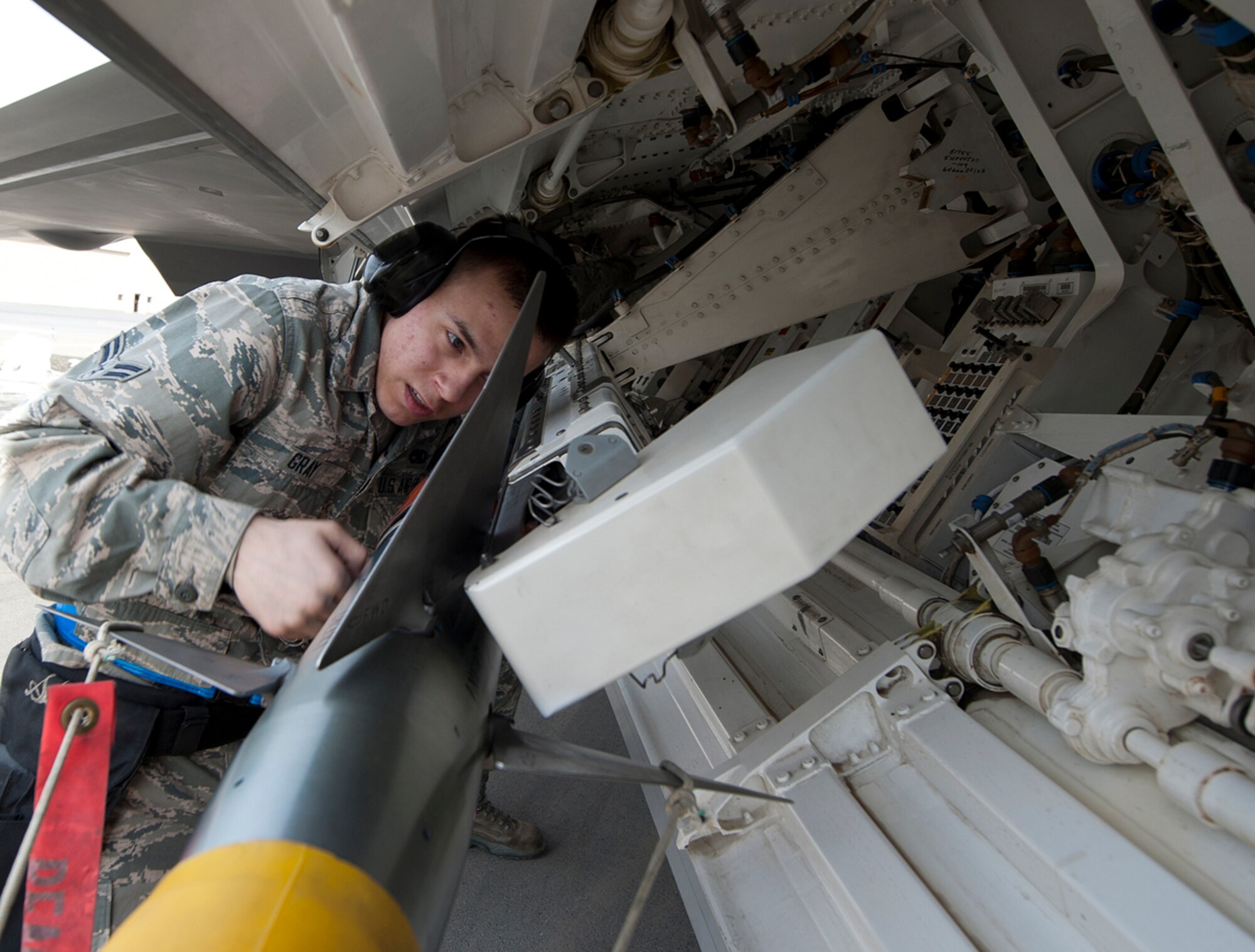 Airman 1st Class Christian Gray secures an AIM-9 Sidewinder missile onto an F-22 Raptor during a 3rd Maintenance Group load crew competition at Joint Base Elmendorf-Richardson, Alaska, April 18, 2014. Gray is a 525th Aircraft Maintenance Unit load crew member and native of Las Angeles. (U.S. Air Force photo/Staff Sgt. Robert Barnett)