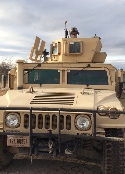 Airman 1st Class Brandon Fackler, a fire team member of the 302nd Security Forces Squadron is ready for action as peers from on top a Humvee.
  
Twenty members of the 302nd SFS attended Patriot Defender training at Fort Wolters, Texas, Feb. 1, 2014. This 16-day training concentrates on combat deployment type situations. Patriot Defender is broken into two halves of training. First the Airmen learned and refined such skills as mission planning and development, land navigation, and M-4 and M-9 firing. The second half concentrated detainee and POW procedures, tactical combat casualty care and urban operations among many other topics. The final three days of the second half of training were dedicated to field training. This involved putting the new and refined skills into practice. The units were briefed on a mission and given a different task each day. 

“Overall, this experience not only taught us a lot but also gave us the chance to apply what we learned,” said Senior Airman Jessica Avila, a fire team member with the 302nd SFS. “Our motivation and positive attitude throughout our training brought out the best in all of us.” (U.S. Air Force photo/Senior Airman Jessica Avila)