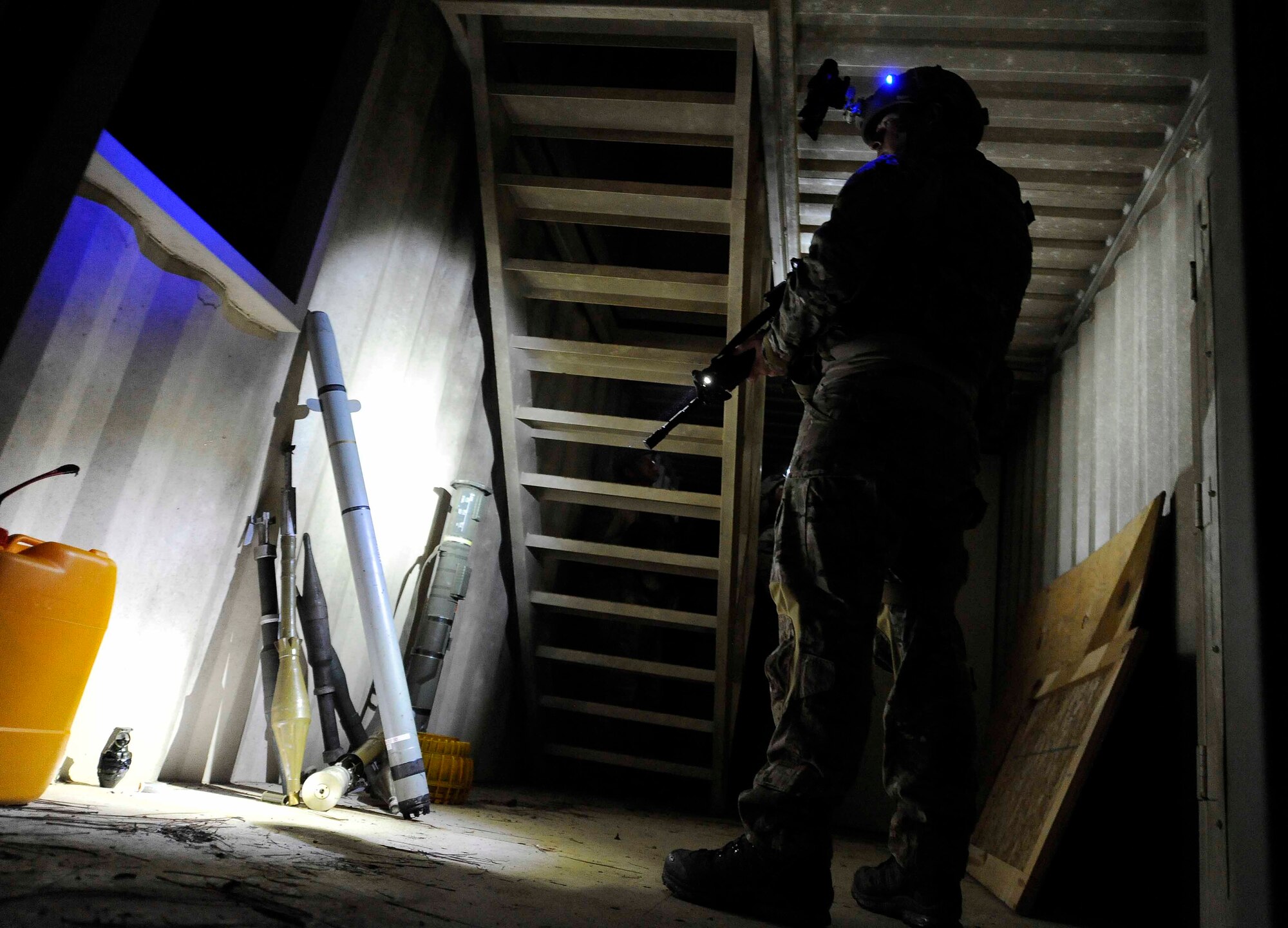 A 1st Special Operations Civil Engineer Squadron explosive ordnance disposal team member secures enemy weapons during a hostage training scenario at Hurlburt Field, Fla., April 24, 2014. Team members searched a bunker to rescue hostages during the training. (U.S. Air Force photo/Airman 1st Class Andrea Posey)