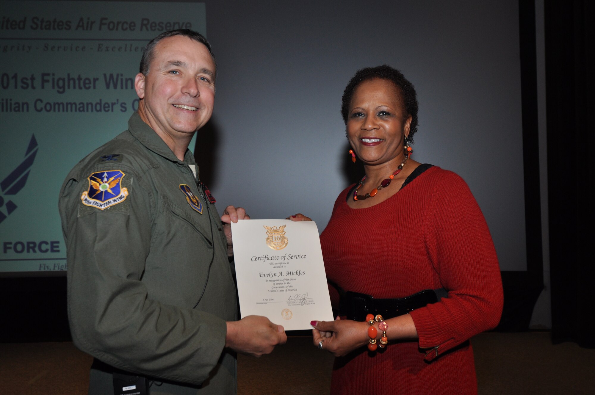 Ms. Evelyn Mickles, 301st Fighter Wing Legal office manager, receives her 10-year pin and certificate for civilian service from Col. John Breazeale, 301st FW commander, at a ceremony April 7, 2014.