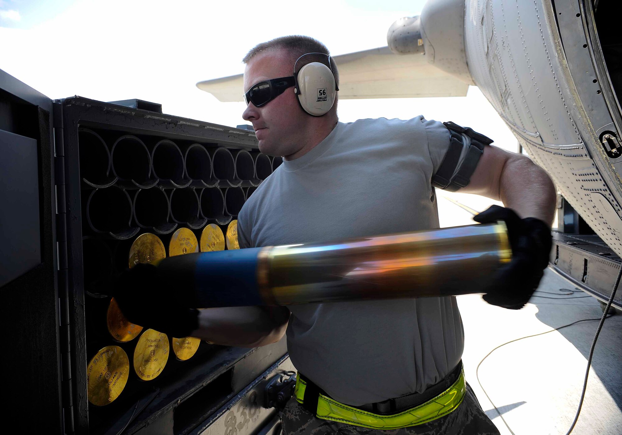 Senior Airman Ryan Hudalla, 1st Special Operations Equipment Maintenance Squadron munitions line delivery crew chief, loads ammunition shells onto an aircraft at Hurlburt Field, Fla., April 23, 2014. The 1st SOEMS is comprised of five flights; more than 300 people provide essential maintenance with a broad range of capabilities. (U.S. Air Force photo/Airman 1st Class Andrea Posey)