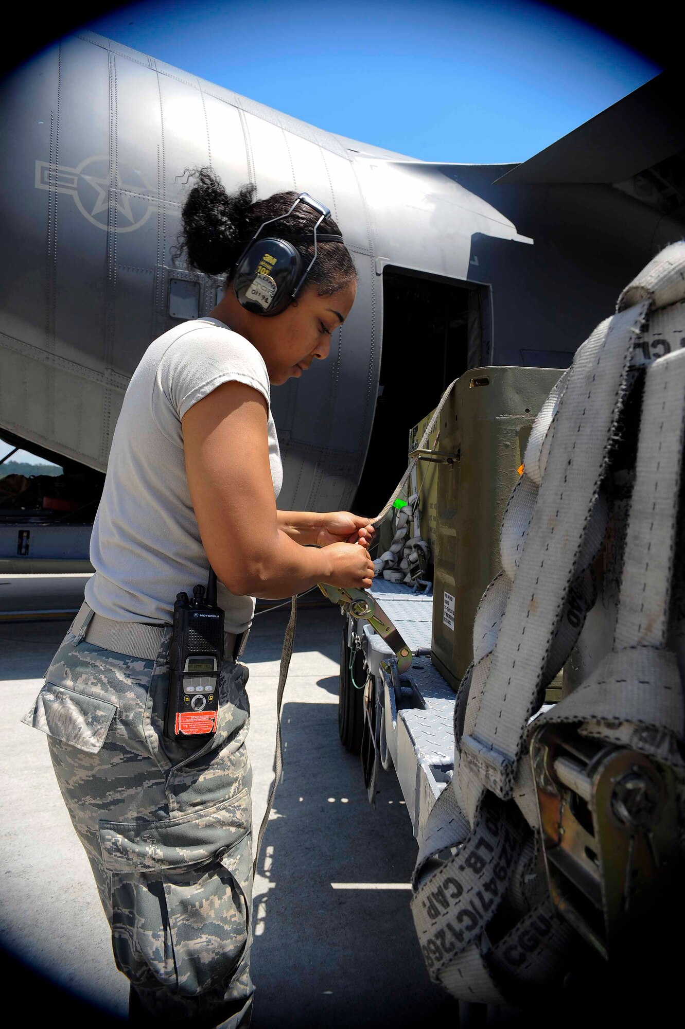 Airman 1st Class Paisley Spencer, 1st Special Operations Equipment Maintenance Squadron munitions line delivery crew member, secures ammunitions containers at Hurlburt Field, Fla., April 23, 2014. The munitions flight provides storage, assembly, delivery, inspection and control of conventional munitions. (U.S. Air Force photo/Airman 1st Class Andrea Posey)