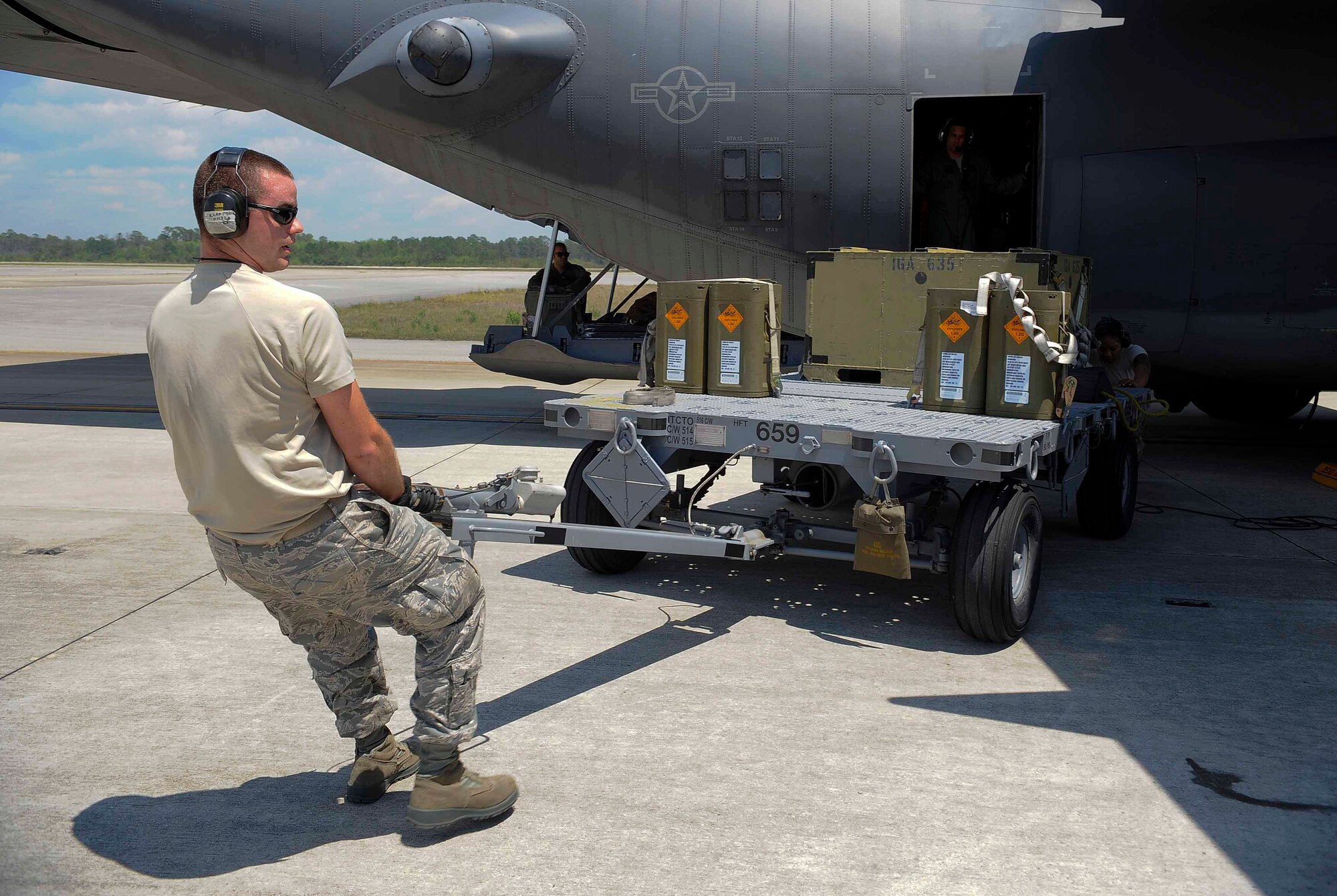 Senior Airman Patrick Bean, 1st Special Operations Equipment Maintenance Squadron munitions line delivery crew chief, hauls ammunitions containers at Hurlburt Field, Fla., April 23, 2014. The 1st SOEMS is comprised of five flights; more than 300 people provide essential maintenance with a broad range of capabilities. (U.S. Air Force photo/Airman 1st Class Andrea Posey)