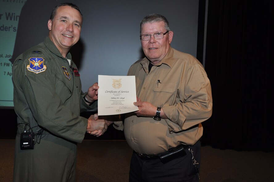 Mr. Sid Lloyd, 301st Fighter Wing Information Protection, receives his 20-year pin and certificate for civilian service from Col. John Breazeale, 301st FW commander, at a ceremony April 7, 2014.