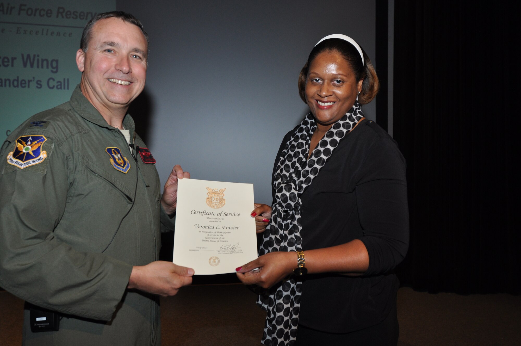 Ms. Veronica Frazier, 301st Fighter Wing Financial Management, receives her 20-year pin and certificate for civilian service from Col. John Breazeale, 301st FW commander, at a ceremony April 7, 2014.