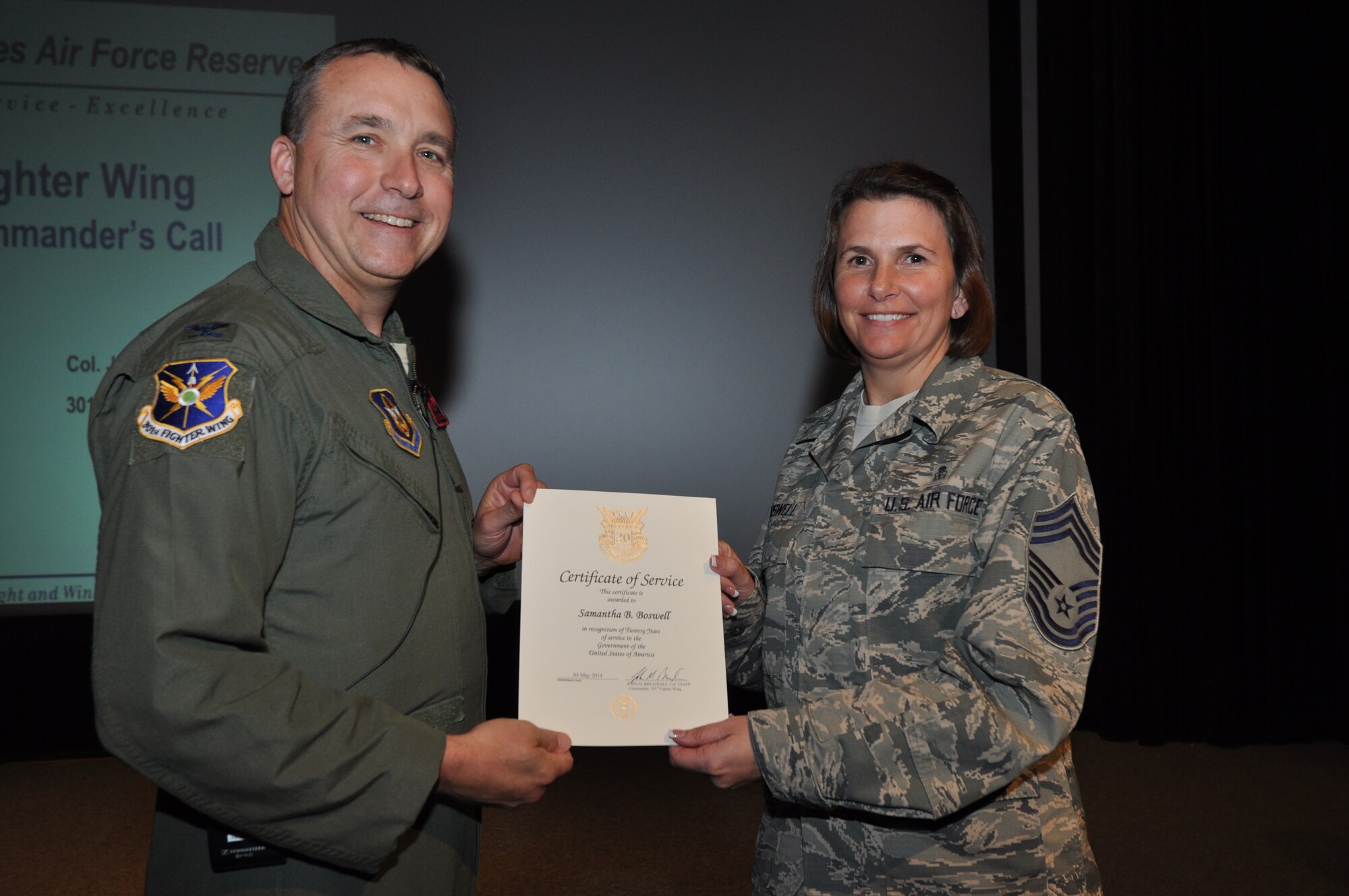 Chief Master Sgt. Samantha Boswell, 301st Medical Squadron's health services chief, receives her 20-year pin and certificate for civilian service from Col. John Breazeale, 301st Fighter Wing commander, at a ceremony  April 7, 2014.