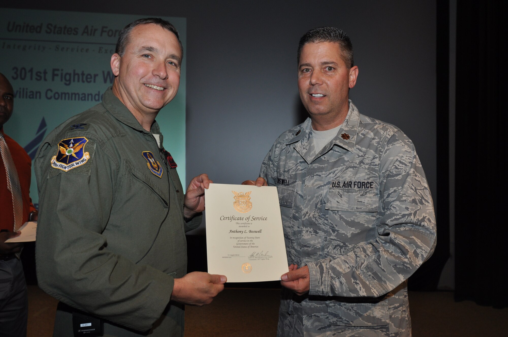 Maj. Anthony Boswell, 301st Force Support Squadron commander, receives his 20-year pin and certificate for civilian service from Col. John Breazeale, 301st Fighter Wing commander, at a ceremony April 7, 2014.