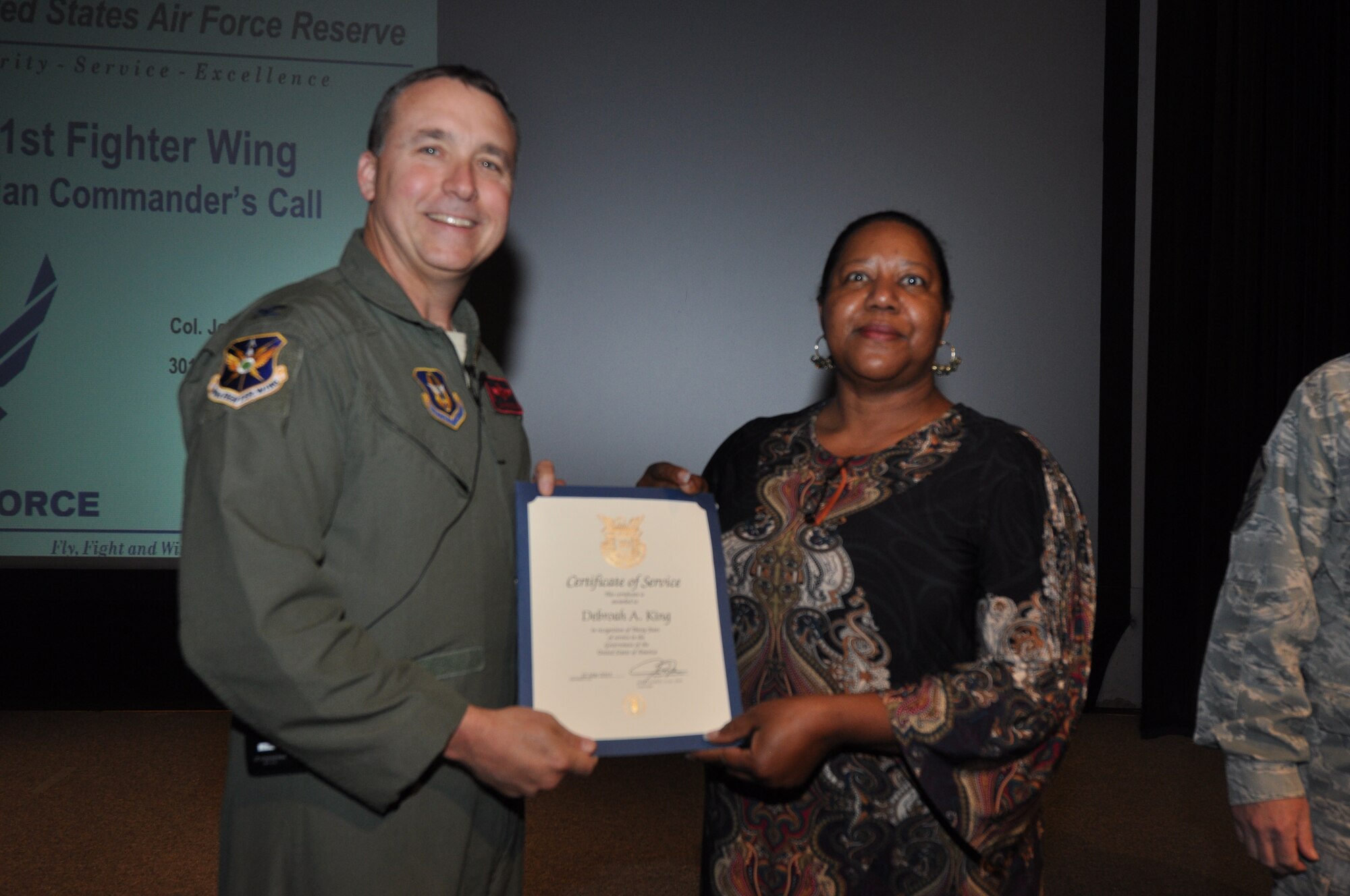 Ms. Debroah King, 301st Logistics Readiness Squadron, receives her 30-year pin and certificate for civilian service from Col. John Breazeale, 301st Fighter Wing commander, at a ceremony April 7, 2014.