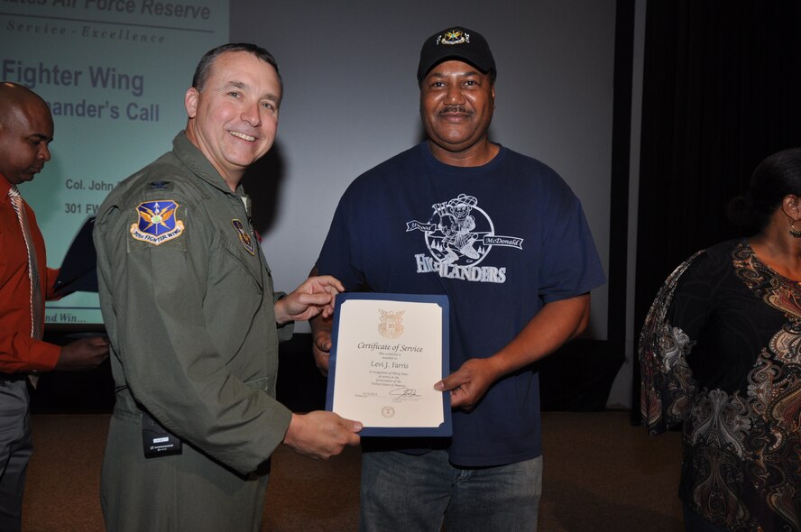 Mr. Levi Farris, 301st Aircraft Maintenance Squadron aircraft systems, receives his 30-year pin and certificate for civilian service from Col. John Breazeale, 301st Fighter Wing commander, at a ceremony April 7, 2014.