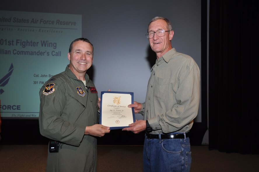 Mr. Jay Evans, 301st Fighter Wing Family Readiness director, receives his 40-year pin and certificate for civilian service from Col. John Breazeale, 301st FW commander, at a ceremony April 7, 2014.