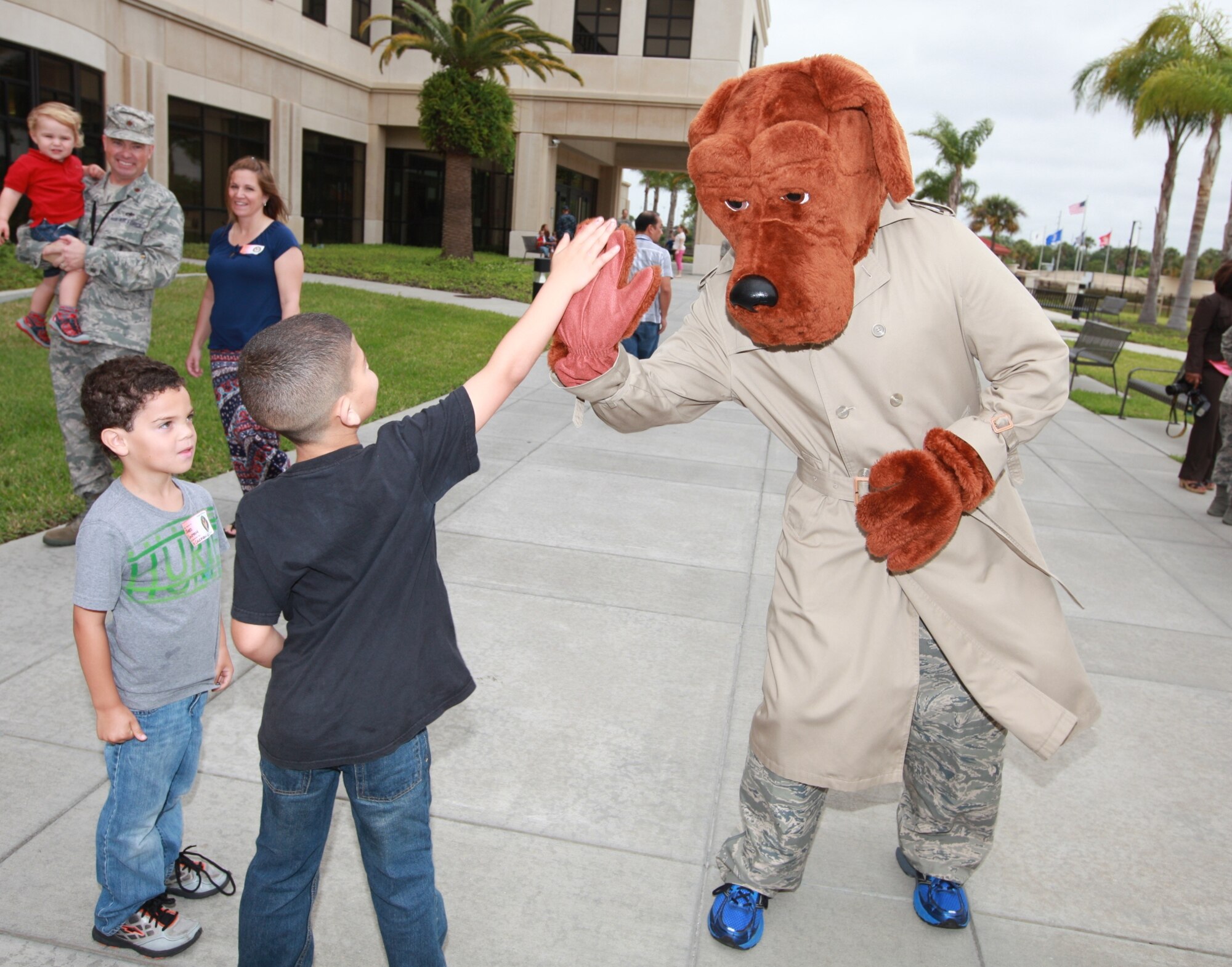 Trent, son of Sgt. Fredrick J. Coleman, U.S. Central Command public affairs, slaps a high-five to McGruff the Crime Dog during the USCENTCOM’s Family Open House at MacDill Air Force Base, Fla., April 18. Good to see he’s still spreading the good word to stay away from drugs. (U.S. Marine Corps photo by Sgt. Fredrick J. Coleman/Released)