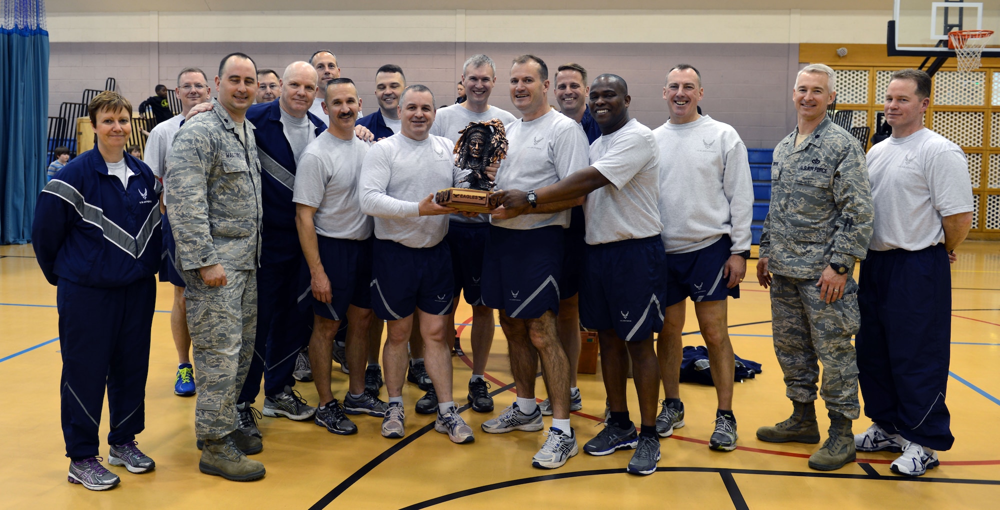 Team Mildenhall leaders hold the "Chiefs vs. Eagles" trophy April 23, 2014, on RAF Mildenhall, England. After facing off in multiple Earth Week-themed events, the Eagles, a team composed of Team Mildenhall commanders, won 3-0 against the Chiefs, a team composed of Team Mildenhall chief master sergeants. (U.S. Air Force photo by Airman 1st Class Preston Webb/Released)