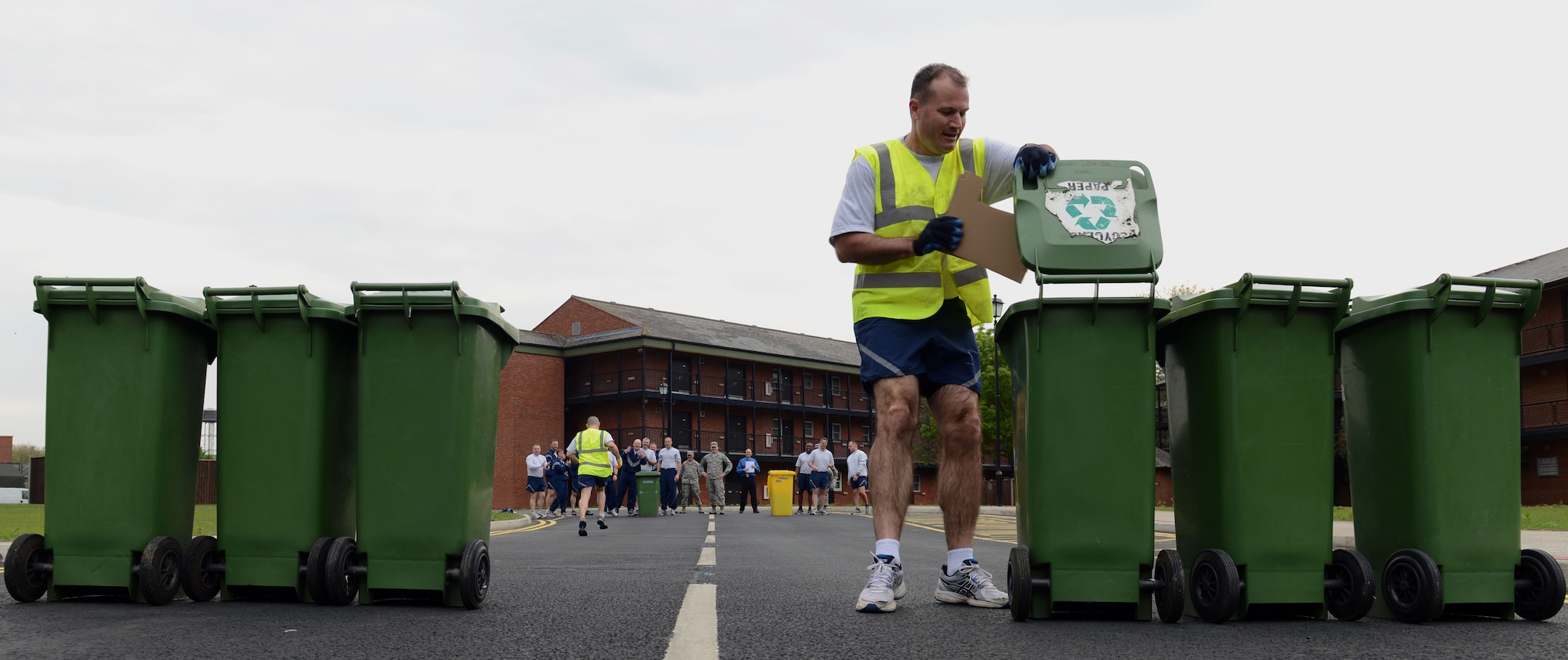 U.S. Air Force Col. Kenneth T. Bibb Jr., 100th Air Refueling Wing commander, recycles cardboard during a relay race April 23, 2014, on RAF Mildenhall, England. Team Mildenhall commanders and chiefs competed by sorting recyclables during a "Chiefs vs. Eagles" event inspired by Earth Week. (U.S. Air Force photo by Airman 1st Class Preston Webb/Released)