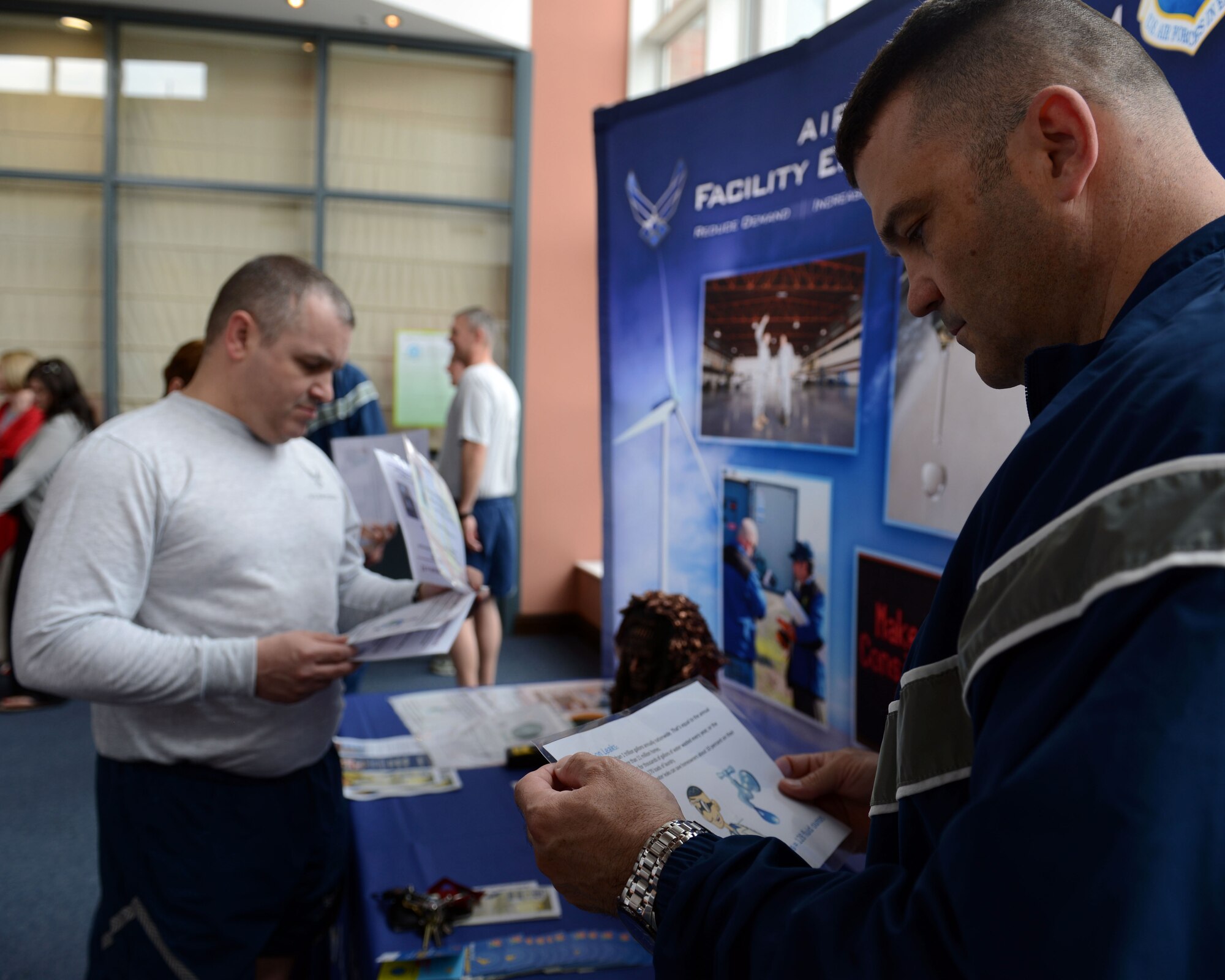 U.S. Air Force Chief Master Sgt. Paul Wallace, left, 100th Operations Group superintendent, and U.S. Air Force Chief Master Sgt. Brian Schexnider, 100th Logistics Readiness Squadron superintendent, study facts about recycling April 23, 2014, on RAF Mildenhall, England. The chiefs reviewed the material as part of a trivia contest against Team Mildenhall commanders during an Earth Week-themed "Chiefs vs. Eagles" competition. (U.S. Air Force photo by Airman 1st Class Preston Webb/Released)