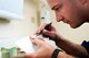 Tech. Sgt. Tim McGee, 60th Dental Squadron maxillofacial laboratory technician, applies the final touches to a prosthetic he has been working on Monday in the David Grant USAF Medical Center Dental Clinic.(U.S. Air Force photo/Staff Sgt. Patrick Harrower)