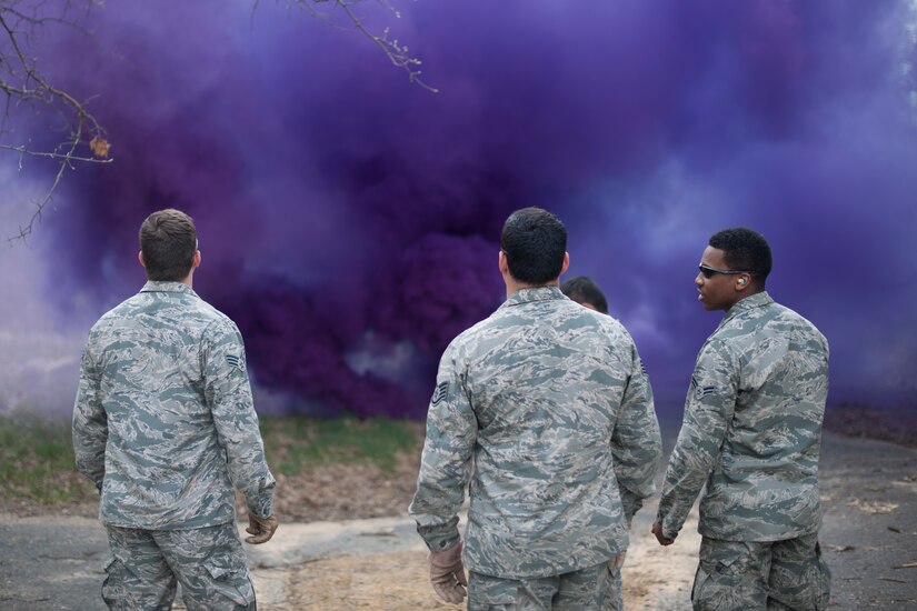 Members of the 11th Civil Engineer Squadron Explosive Ordnance Disposal unit and 113th Wing Operations Support Flight observe a cloud created by their M18 smoke grenades during training here, April 17.  (U.S. Air Force photo/Staff Sgt. Robert Cloys)