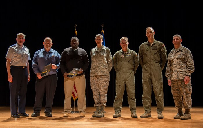 Col. Al Miller, 437th Airlift Wing vice commander (left), and Chief Master Sgt. Shawn Hughes, 437th AW command chief (right), gather with the Quarterly Award winners for a group photo Apr. 24, 2014, at the Base Theater on Joint Base Charleston – Air Base, S.C. The Quarterly Awards are held to recognize outstanding Airmen, noncommisioned officers, senior noncomissioned officers, company grade officers and civilians for their hard work and dedication. (U.S. Air Force photo/ Airman 1st Class Clayton Cupit)