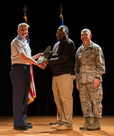 Col. Al Miller, 437th Airlift Wing vice commander (left), and Chief Master Sgt. Shawn Hughes, 437th AW command chief (right), present the Category I Civilian Award to Julius Murray, 437th Aerial Port Squadron hazardous cargo shipment inspector Apr. 24, 2014, at the Base Theater on Joint Base Charleston – Air Base, S.C. The Quarterly Awards are held to recognize outstanding Airmen, noncommisioned officers, senior noncomissioned officers, company grade officers and civilians for their hard work and dedication. (U.S. Air Force photo/ Airman 1st Class Clayton Cupit)