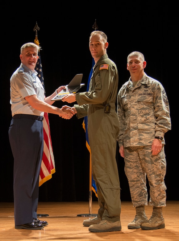 Col. Al Miller, 437th Airlift Wing vice commander (left), and Chief Master Sgt. Shawn Hughes, 437th AW command chief (right), present the Senior Noncomissioned Officer of the Quarter Award to Master Sgt. Christopher Copans, 437th Operations Group loadmaster superintendent, Special Operations Division Apr. 24, 2014, at the Base Theater on Joint Base Charleston – Air Base, S.C. The Quarterly Awards are held to recognize outstanding Airmen, noncommisioned officers, senior noncomissioned officers, company grade officers and civilians for their hard work and dedication. (U.S. Air Force photo/ Airman 1st Class Clayton Cupit)