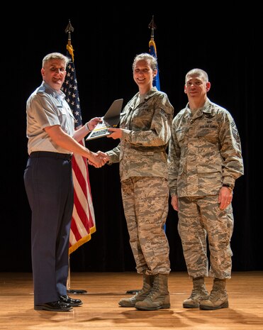 Col. Al Miller, 437th Airlift Wing vice commander (left), and Chief Master Sgt. Shawn Hughes, 437th AW command chief (right), present the Noncomissioned Officer of the Quarter Award to Staff Sgt. Maelyn Belmondo, 437th Operations Support Squadron weather specialist Apr. 24, 2014, at the Base Theater on Joint Base Charleston – Air Base, S.C. The Quarterly Awards are held to recognize outstanding Airmen, noncommisioned officers, senior noncomissioned officers, company grade officers and civilians for their hard work and dedication. (U.S. Air Force photo/ Airman 1st Class Clayton Cupit)