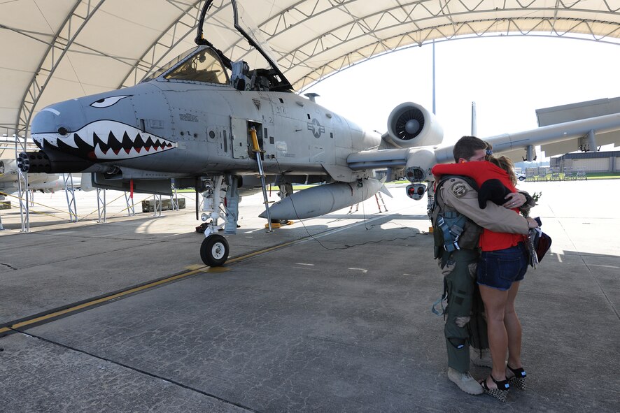 Air Force Capt. Clay Quinby, an A-10C Thunderbolt II pilot assigned to the 75th Fighter Squadron, hugs his wife Lacey at Moody Air Force Base, Ga., April 23, 2014.   Lacey greeted her husband on the flight line when he returned from a six-month deployment to Afghanistan. (U.S. Air Force photo by Master Sgt. Sonny Cohrs/Released)

