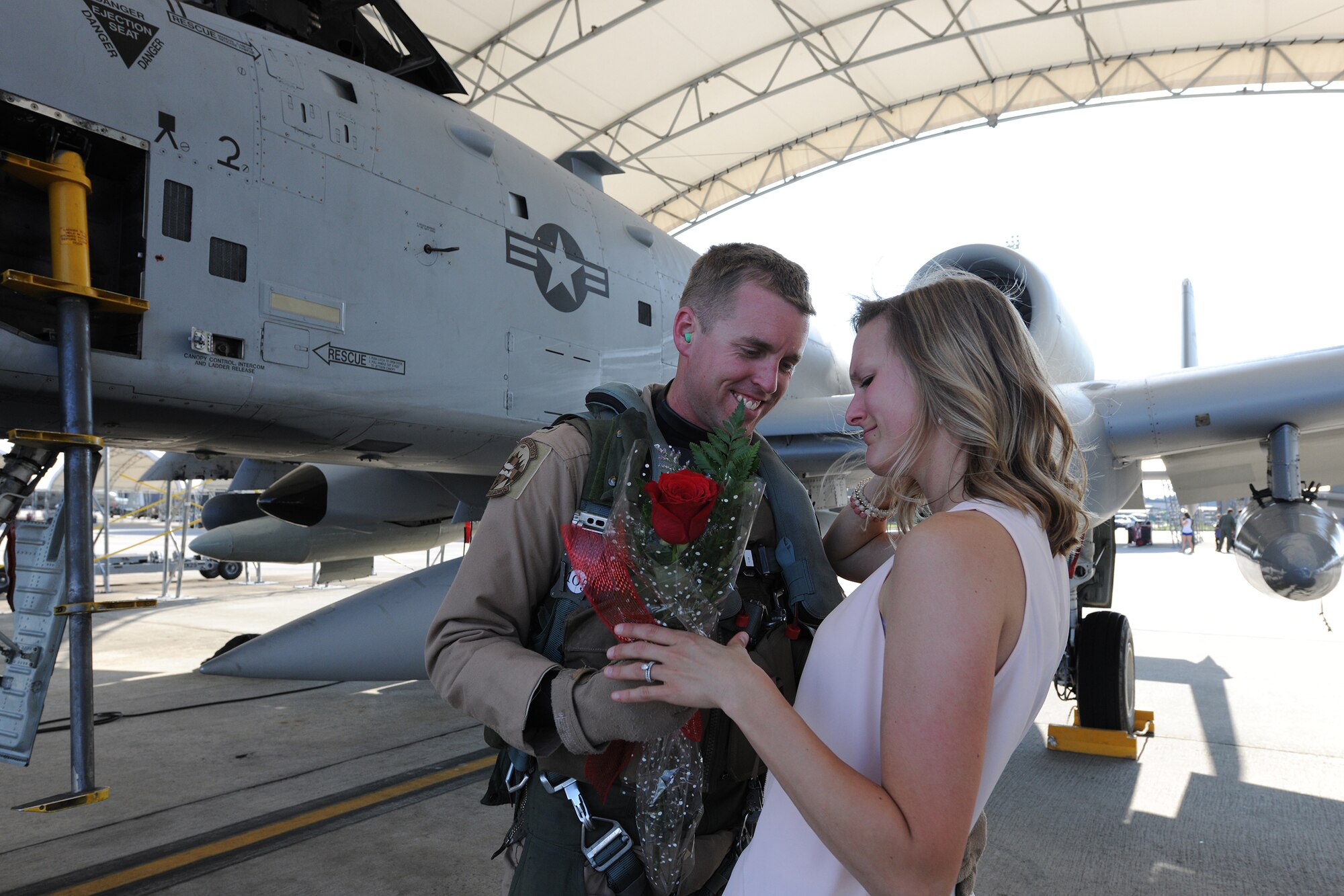 U.S. Air Force 1st Lt. Gregory George, an A-10C Thunderbolt II pilot assigned to the 75th Fighter Squadron, gives a rose to his wife, Meredith, April 23, 2014, at Moody Air Force Base, Ga.  George returned to Moody following a six-month deployment to Bagram Airfield, Afghanistan, with his unit. (U.S. Air Force photo by Master Sgt. Sonny Cohrs/Released)