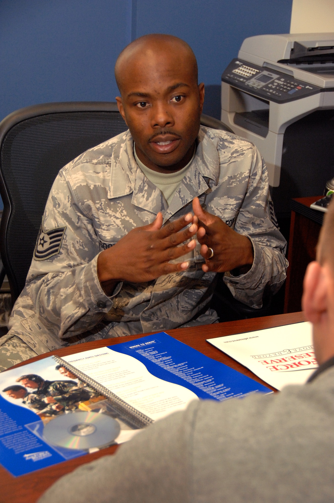 Tech. Sgt. Clarence ‘Brandon’ Goodloe (left), Offutt’s new in service Air Force Reserve recruiter, meets with Reserve recruit, Senior Airman Kurt McGhee, at his office April 18, 2014. Goodloe is assigned fulltime to Offutt, and will assist Team Offutt’ members interested in joining the Air Force Reserve. (U.S. Air Force Photo/Delanie Stafford)