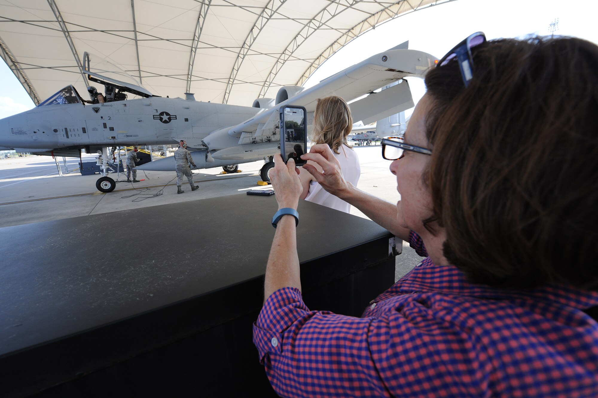 Judy George, mother of Air Force 1st Lt. Gregory George, an A-10C Thunderbolt II pilot assigned to the 75th Fighter Squadron, takes a cell phone video of her son’s arrival April 23, 2014, at Moody Air Force Base, Ga.  George returned from a six-month deployment to Bagram Airfield, Afghanistan, and was greeted by his family on the flight line. (U.S. Air Force photo by Master Sgt. Sonny Cohrs/Released)
