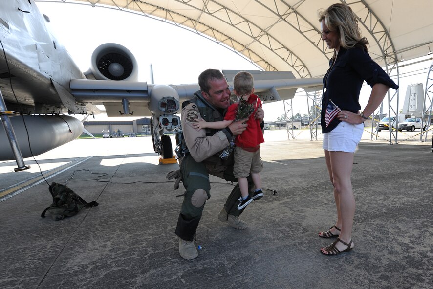 U.S. Air Force Capt. Leif Nordhagen, an A-10C Thunderbolt II pilot assigned to the 75th Fighter Squadron, hugs his son Lars and greets his wife Amy at Moody Air Force Base, Ga., April 23, 2014, following his six-month deployment to Afghanistan. A total of five pilots returned to Moody April 23 and were greeted by their friends and family on the flight line. (U.S. Air Force photo by Master Sgt. Sonny Cohrs/Released)