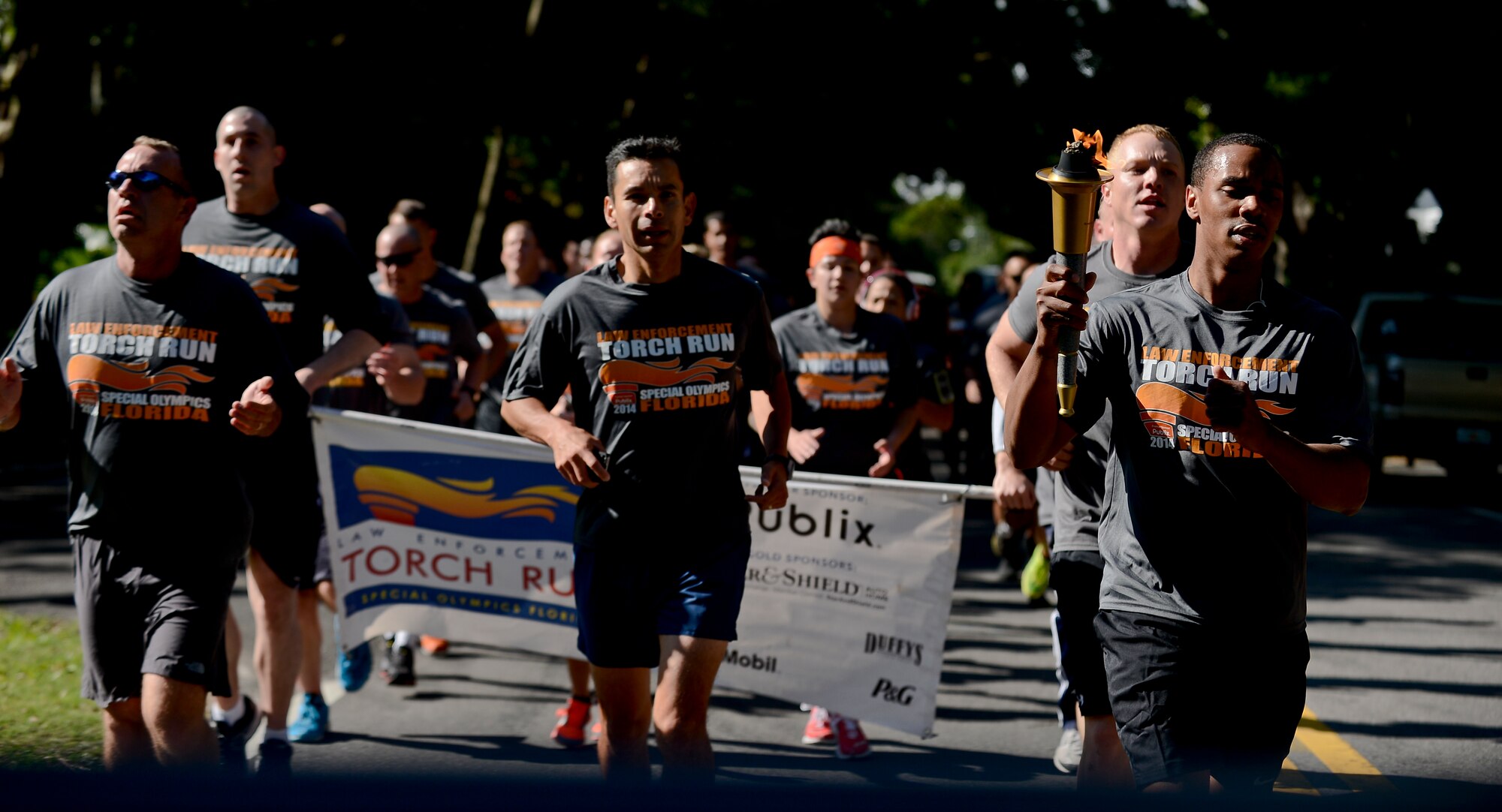 Members from MacDill Air Force Base run down Bayshore Blvd. in Tampa, Fla., during the Special Olympics Florida Law Enforcement torch run, April 16, 2014. More than 50 6th Security Forces Squadron members, to include the 6th Mission Support Group commander, Col. Peter Santa Ana, participated in the 2.7 -mile -formation run.  (U.S. Air Force photo by Senior Airman Melanie Bulow-Gonterman/Released)