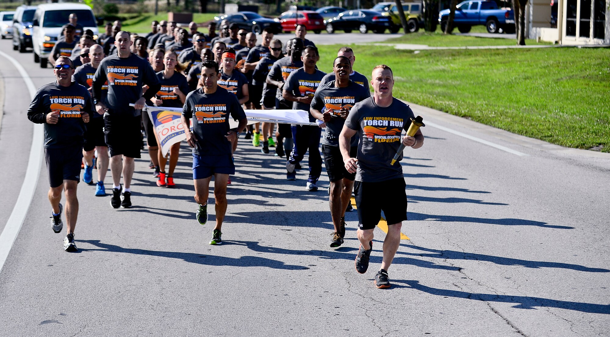Staff Sgt. Shannon Hutto, 6th Security Forces Squadron military working dog trainer, leads the formation run during the  Special Olympics Florida Law Enforcement torch run, April 16, 2014 at MacDill Air Force Base, Fla. More than 50 6th SFS members, to include the 6th Mission Support Group commander, Col. Peter Santa Ana, participated in the 2.7- mile- formation run. (U.S. Air Force photo by Senior Airman Melanie Bulow-Gonterman/Released) 
