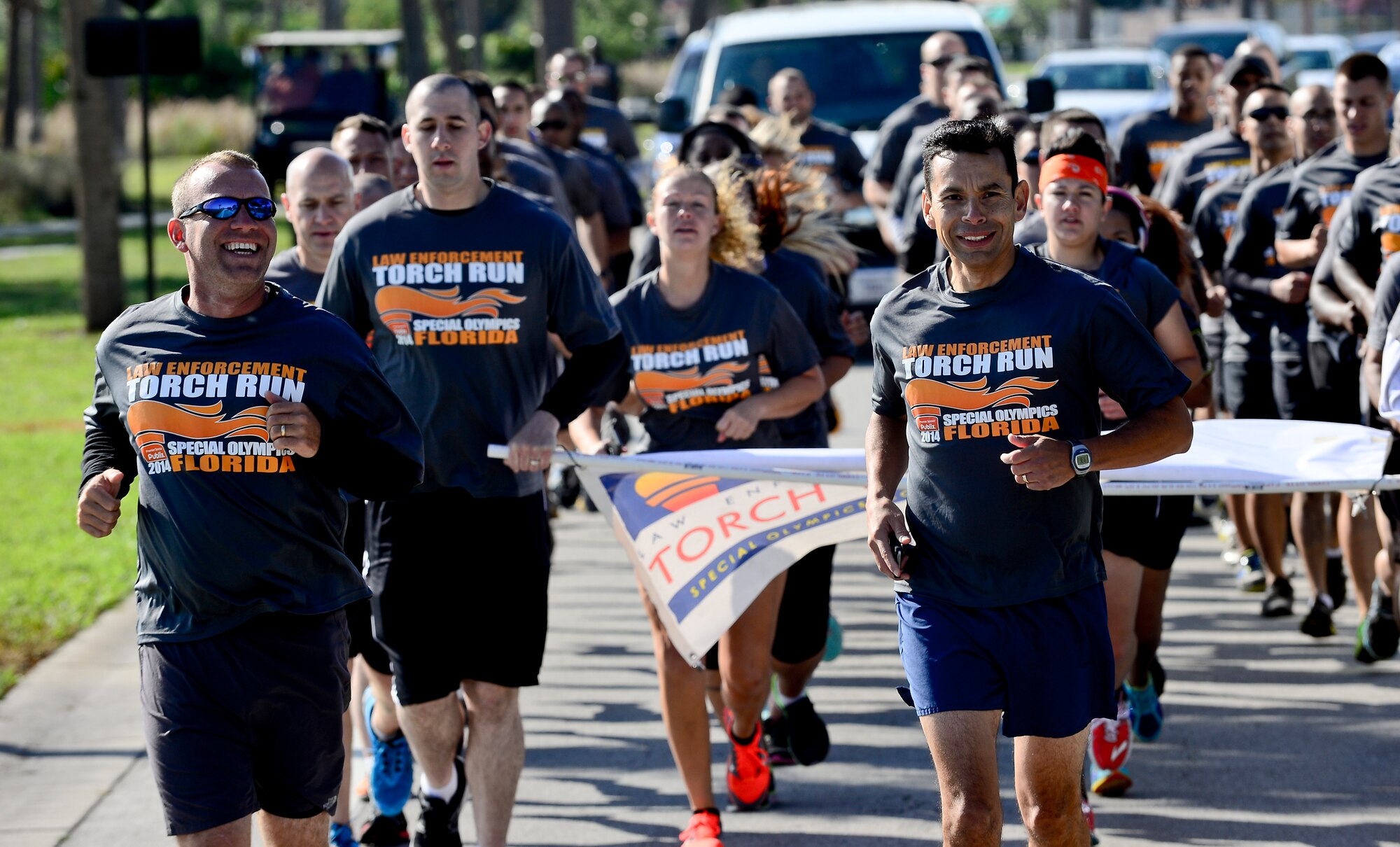 Col. Peter Santa Ana, 6th Mission Support Group commander, and members from the 6th Security Forces Squadron participate in the annual Special Olympics Florida Law Enforcement torch run, April 16, 2014 at MacDill Air Force Base, Fla. The 6th SFS has participated in this event since the mid 1990's. (U.S. Air Force photo by Senior Airman Melanie Bulow-Gonterman/Released) 