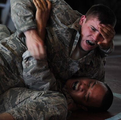 2nd Lt. Travis Seaver, 603rd Air and Space Communications Squadron deputy flight commander C2 systems, and Tech. Sgt. Jose Obregon, 435th Security Forces Squadron independent duty medical technician, participate in a sparring match during the final tournament of the Modern Army Combatives program, April 18, 2014, at Landstuhl Regional Medical Center. The Modern Army Combatives program is used to teach techniques from different mixed martial arts to members of all branches of the U.S. military to prepare for hand-to-hand combat situations. (U.S. Air Force photo/Airman 1st Class Holly Mansfield)