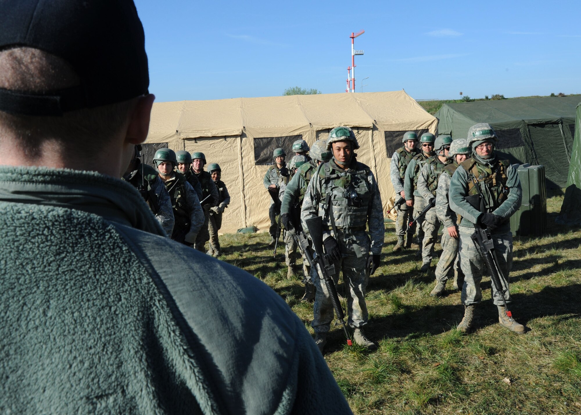 U.S. Air Force Staff Sgt. Robert Messing, a 606th Air Control Squadron security specialist and lead instructor for combat readiness training, explains results of a previous scenario during a CRT exercise April 16, 2014, at Spangdahlem Air Base, Germany. The instructors discussed scenarios and then brought the class together to let Airmen know how they performed and how they could improve.  (U.S. Air Force photo by Airman 1st Class Dylan Nuckolls/Released)