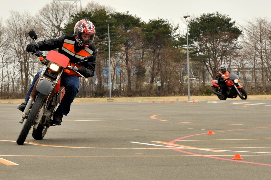 Capt. Michael Carollo, 35th Fighter Wing chaplain, looks ahead into a turn during a motorcycle safety course on Misawa Air Base, Japan, April 21, 2014. The riding season has officially started in Misawa and all motorcyclists must complete a basic rider’s course before they can operate their vehicle. (U.S. Air Force photo/ Staff Sgt. Tong Duong.) 

