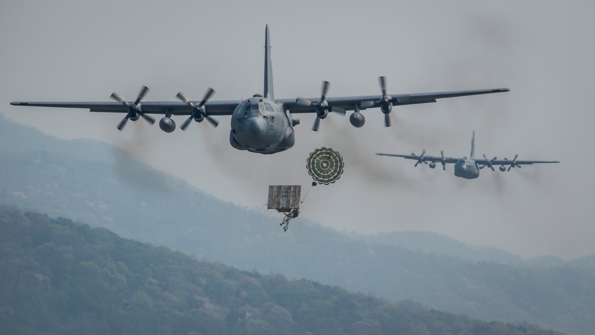 Yokota Air Base C-130H Hercules drop heavy equipment payloads over the Republic of Korea during Exercise Max Thunder, April 18, 2014. Max Thunder is a bilateral air exercise designed to improve interoperability between regional air assets during contingency operations. (U.S. Air Force photo by Capt. Raymond Geoffroy/Released)