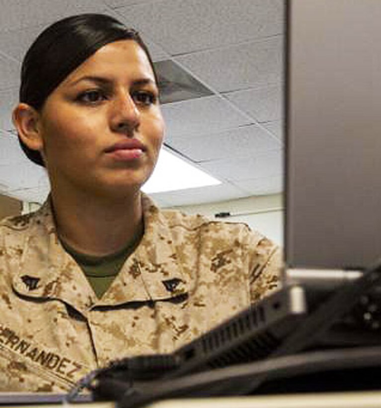 Marine Corps Cpl. Connie Hernandez, a field wireman assigned to the 26th Marine Expeditionary Unit and Los Angeles native, conducts her daily tasks at the 26th MEU command post at Camp Lejeune, N.C., April 22, 2014. Hernandez works with a range of telephony equipment the MEU uses to complete its mission. U.S. Marine Corps photo by Lance Cpl. Joshua W. Brown