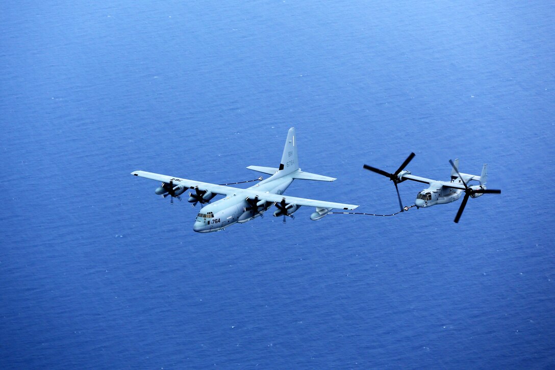 A KC-130J Hercules aircraft refuels an MV-22 Osprey off the coast of North Carolina, April 14, 2014.