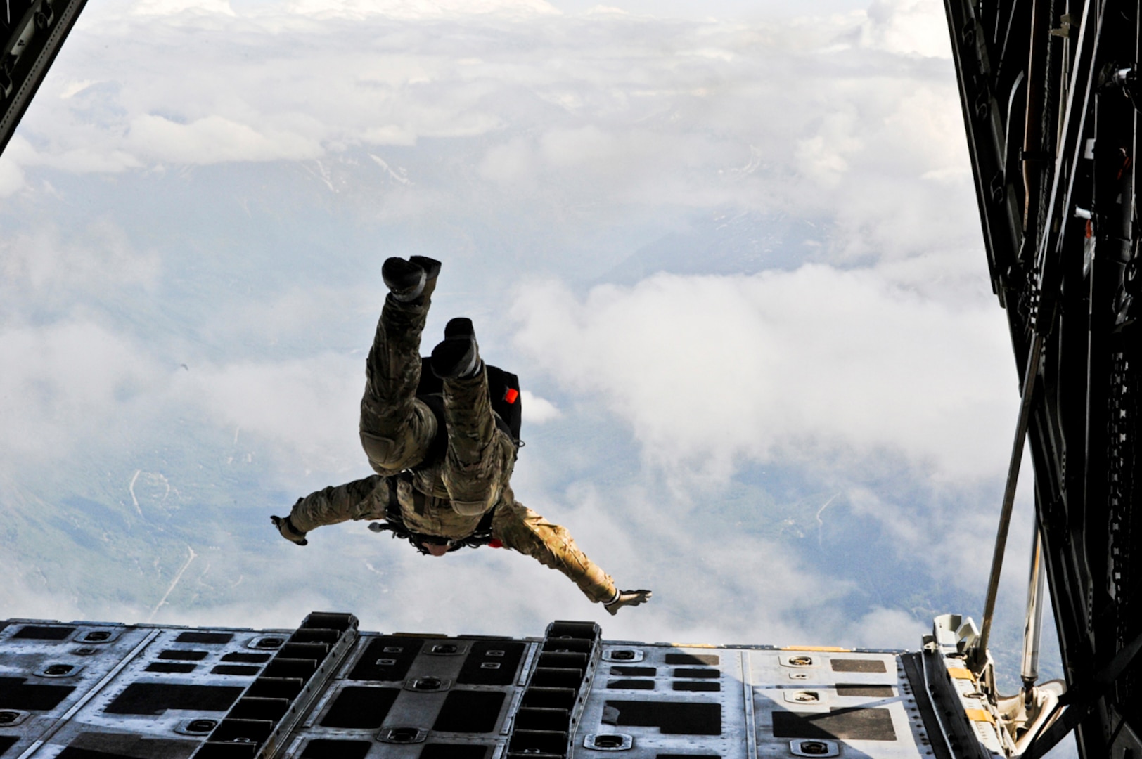 An Alaska Air National Guard 212th Rescue Squadron pararescueman performs a high-altitude jump from a Coast Guard C-130 Hercules during a training mission at Joint Base Elmendorf-Richardson, June 23, 2011. Pararescuemen saved a rafter this week.