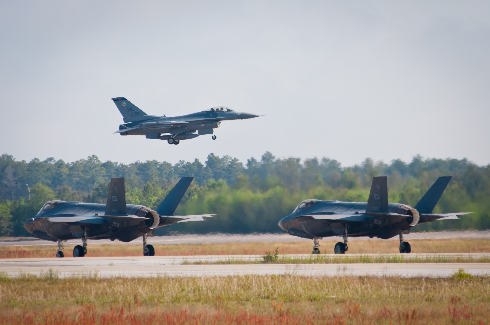 An F-16 Fighting Falcon takes off while two F-35 Lightning IIs taxi on the flightline in a training mission April 24, 2014, at Eglin Air Force Base, Fla. F-16s from the 419th and 388th Fighter Wings from Hill AFB, Utah, conducted their first training missions alongside the U.S. Air Force’s newest fighter aircraft. (U.S. Air Force photo/Staff Sgt. Christina Judd) 