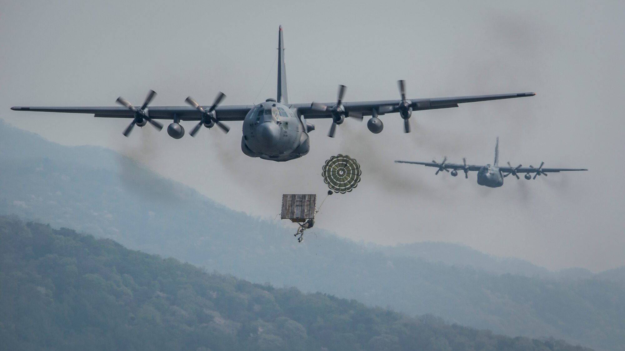 C-130H Hercules drop heavy equipment payloads April 18, 2014, over South Korea, during exercise Max Thunder. Max Thunder is a bilateral air exercise designed to improve interoperability between regional air assets during contingency operations. The aircraft are assigned to Yokota Air Base, Japan. (U.S. Air Force photo/Capt. Raymond Geoffroy)