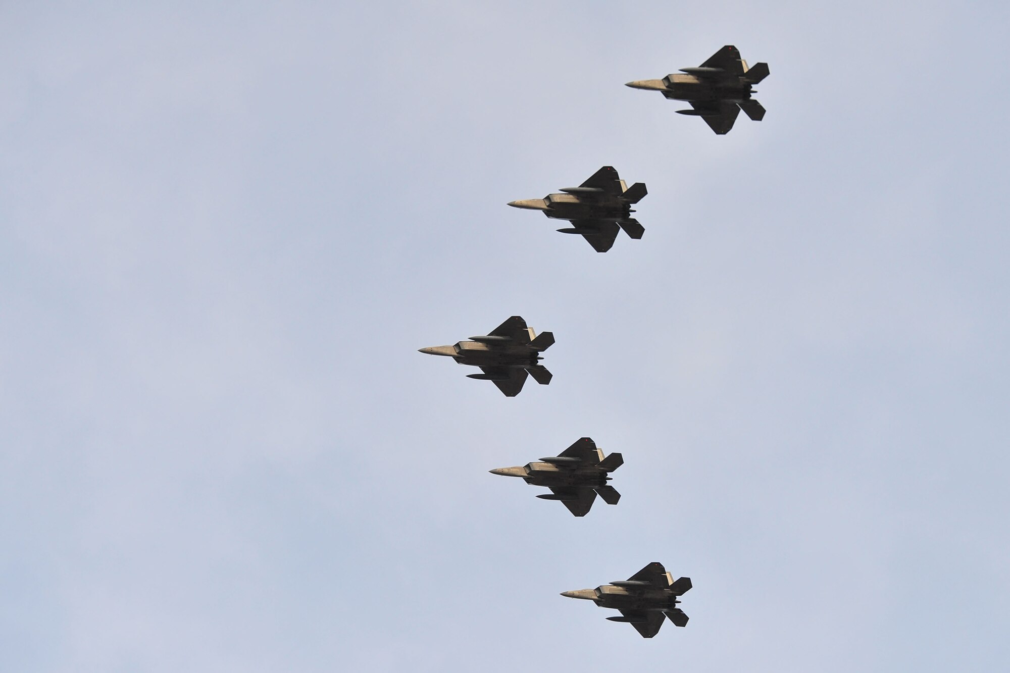 The first five F-22 Raptors for the 95th Fighter Squadron perform a flyover Jan. 6, 2014, at Tyndall Air Force Base, Fla. With all 24 F-22s transferred from Holloman Air Force Base, N.M., Tyndall AFB leaders declared the 95th FS at Initial Operational Capability April 8. (U.S. Air Force photo/Airman 1st Class Dustin Mullen)