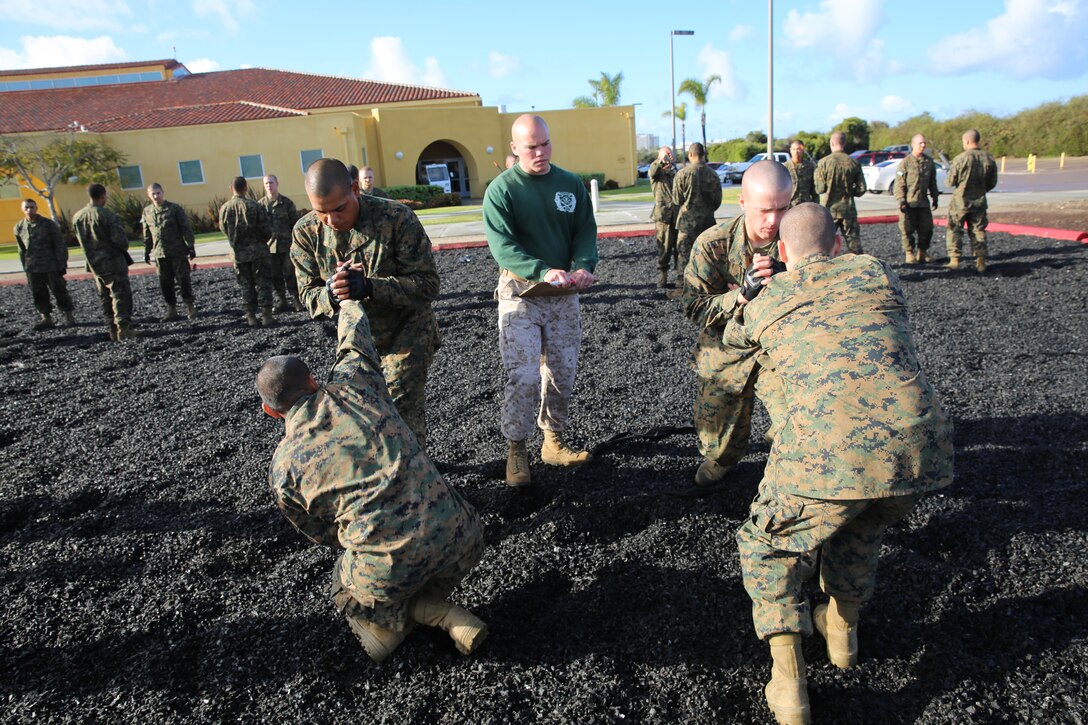 Company M Marines, 3rd Recruit Training Battalion, perform the wrist lock take down technique during their Marine Corps Martial Arts Program test aboard the dpeot, April 2. After recruit training Marines can earn up to a black belt in MCMAP.