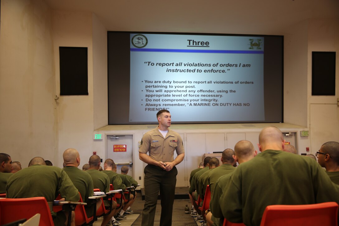 Company K recruits listen to Micheal R. Harrison, drill instructor, Instructional Training Company, Support Battalion, as he teaches them the third general order during the Interior Guard class aboard the depot, April 3. 