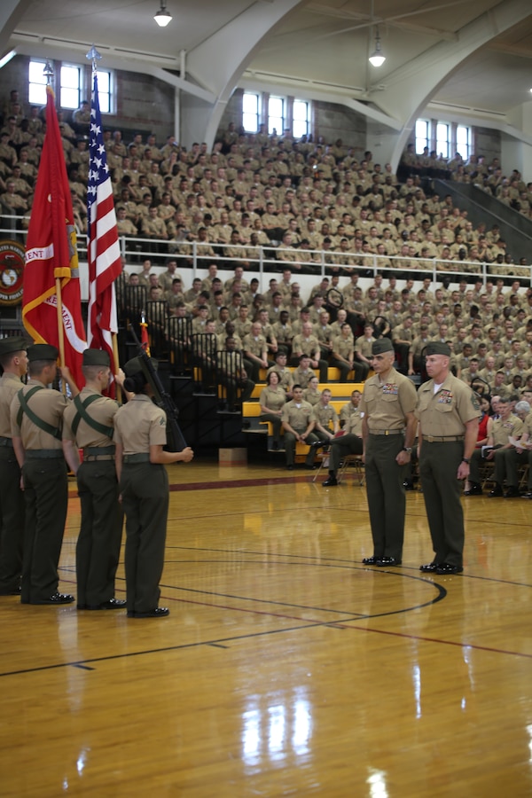 Colonel Clifford J. Weinstein, and Sgt. Maj. Brett C. Scheur, the commanding officer and sergeant major with 10th Marine Regiment, stand before colors in the Goettge Field House as the battle color rededication ceremony began. Marines and sailors with 10th Marine Regiment celebrated the regiment's 100th anniversary April 25, 2014.