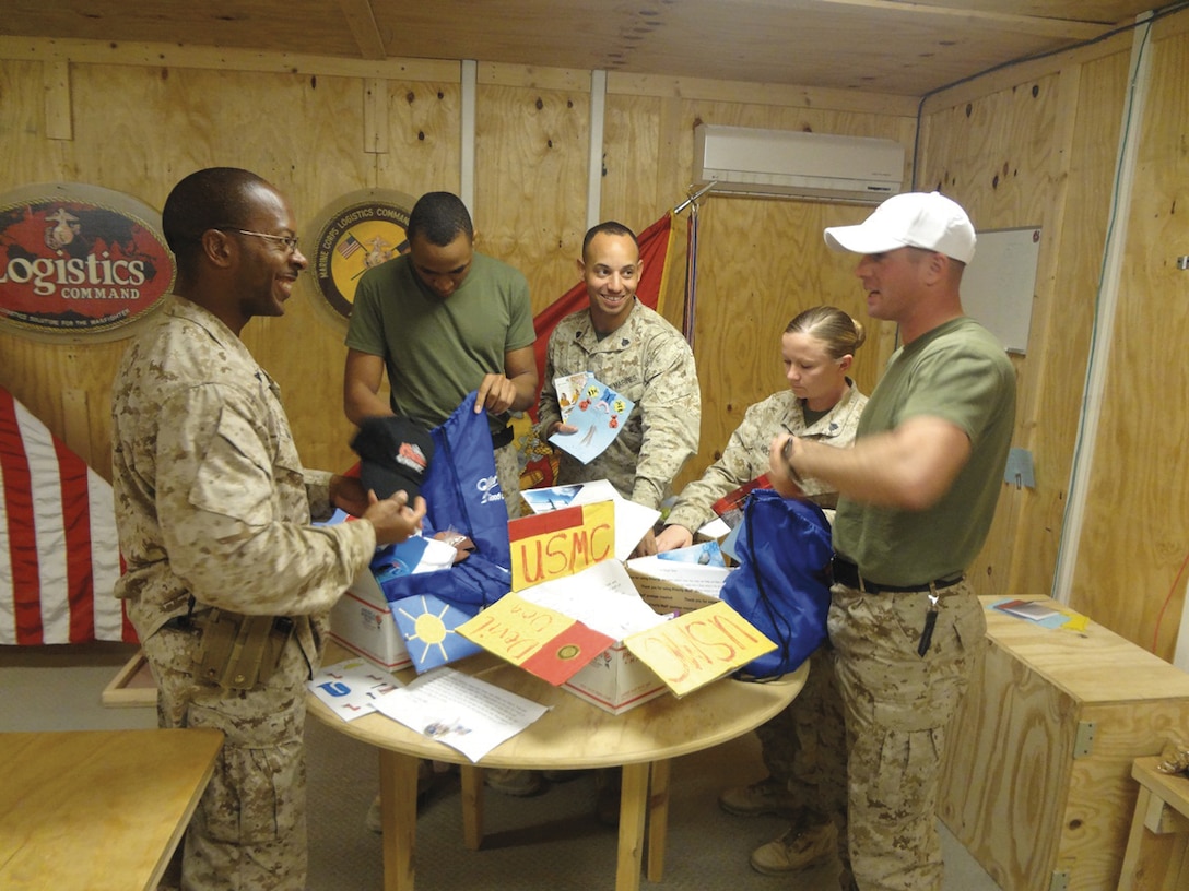 Marines deployed with Marine Corps Logistics Command (Forward) Regional Command Southwest in Afghanistan open care packages sent to them recently from Marine Corps Logistics Base Albany’s Marine Corps Family Team Building. MCFTB raised funds from a bake sale to pay for postage, received donations from MillerCoors in Albany and military spouses helped decorate and pack the boxes. MCFTB also received support from the base’s command, LOGCOM and Marine Corps Community Services.