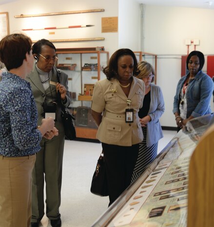 Members of the Dougherty County School System join Marine Corps Logistics Base Albany’s personnel at the ribbon-cutting ceremony and tour the Natural and Cultural Resources Center, Monday.
Julie Robbins, natural resources manager, Installation and Environmental Division, MCLB Albany (left) discussed some of the exhibits on display. Visitors included: Dr. Gail Brown, secondary science content coordinator; Dr. Zeda George, principal and Kristin Williams, international baccalaureate primary year’s program coordinator, both from the International Studies Elementary Charter School in Albany.
