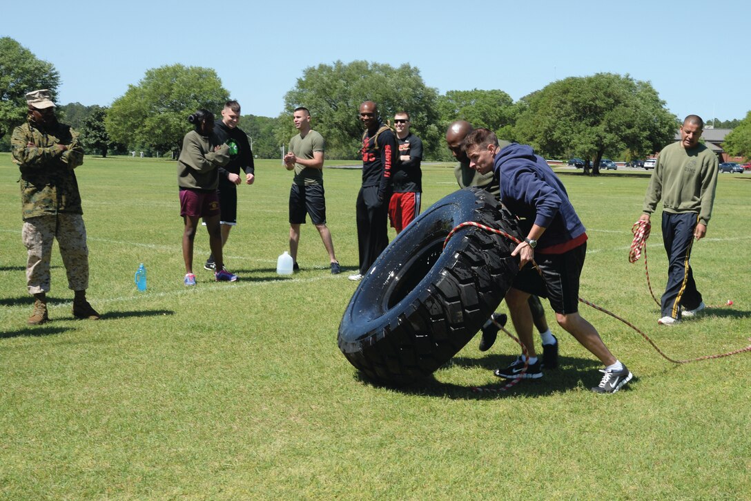 Weapons Systems Management Center’s team tugs and flips their way to victory in the tire-pull-and-flip challenge at Boyett Park, here, April 16, during the Daniels Cup Challenge. 